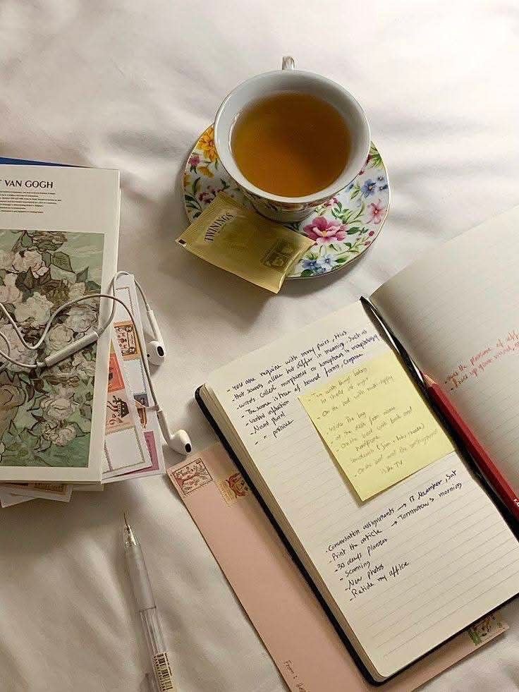 Open journal, cup of tea, and gentle evening light — a calm slow living moment for journaling before bed.