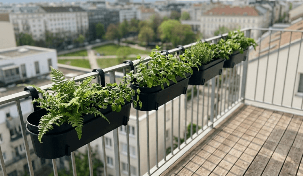 small balcony railing planters with herbs and greenery, space saving vertical garden idea for apartment balcony