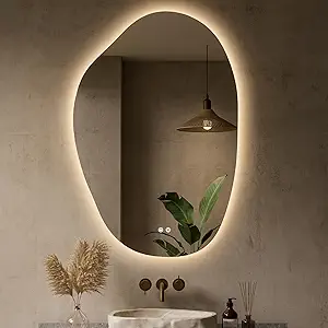 Organic shaped LED backlit mirror adding soft lighting and visual depth to a small modern space