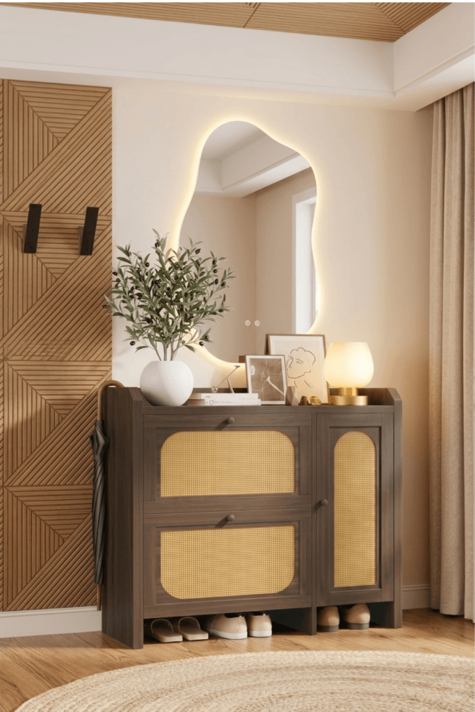 Minimalist small apartment entryway with hidden storage cabinet, organic backlit mirror, warm table lamp, and neutral Japandi decor