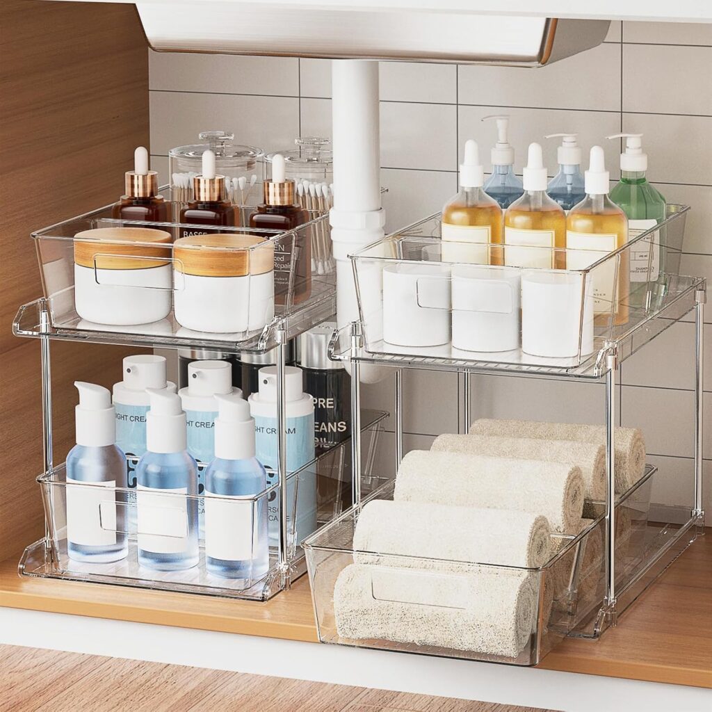 Clear pull-out cabinet organizers creating easier access to bottles, towels, and everyday essentials inside deep cabinets