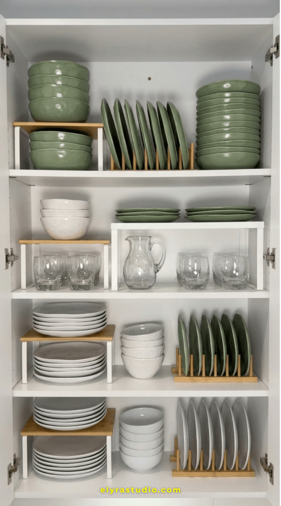 Organized small apartment kitchen cabinet with shelf risers, vertical plate storage, and space saving dish organization ideas that create more storage without visual clutter.