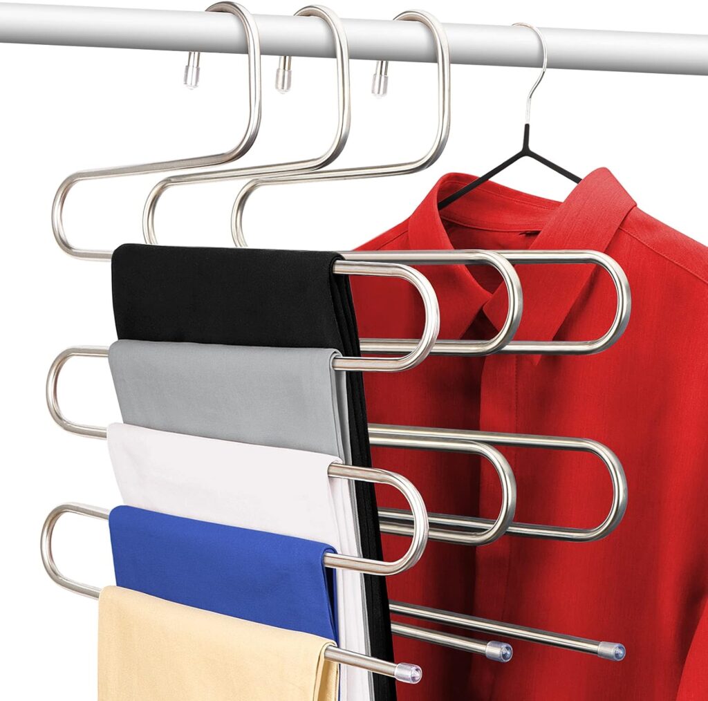 Space saving stainless steel S hangers organizing pants and scarves vertically inside a small bedroom closet