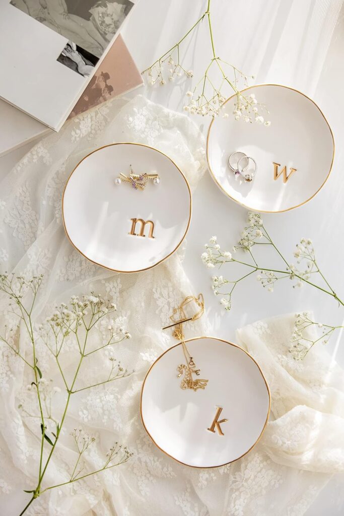 Minimal ceramic jewelry tray on a bedside table organizing rings and necklaces while reducing visual clutter in the bedroom