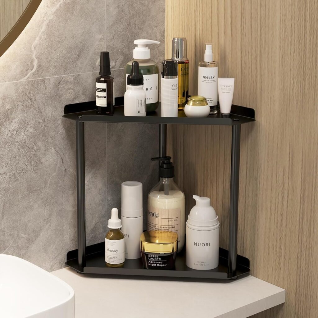 Black two-tier bathroom counter organizer storing skincare and soap bottles in a modern minimalist bathroom corner.