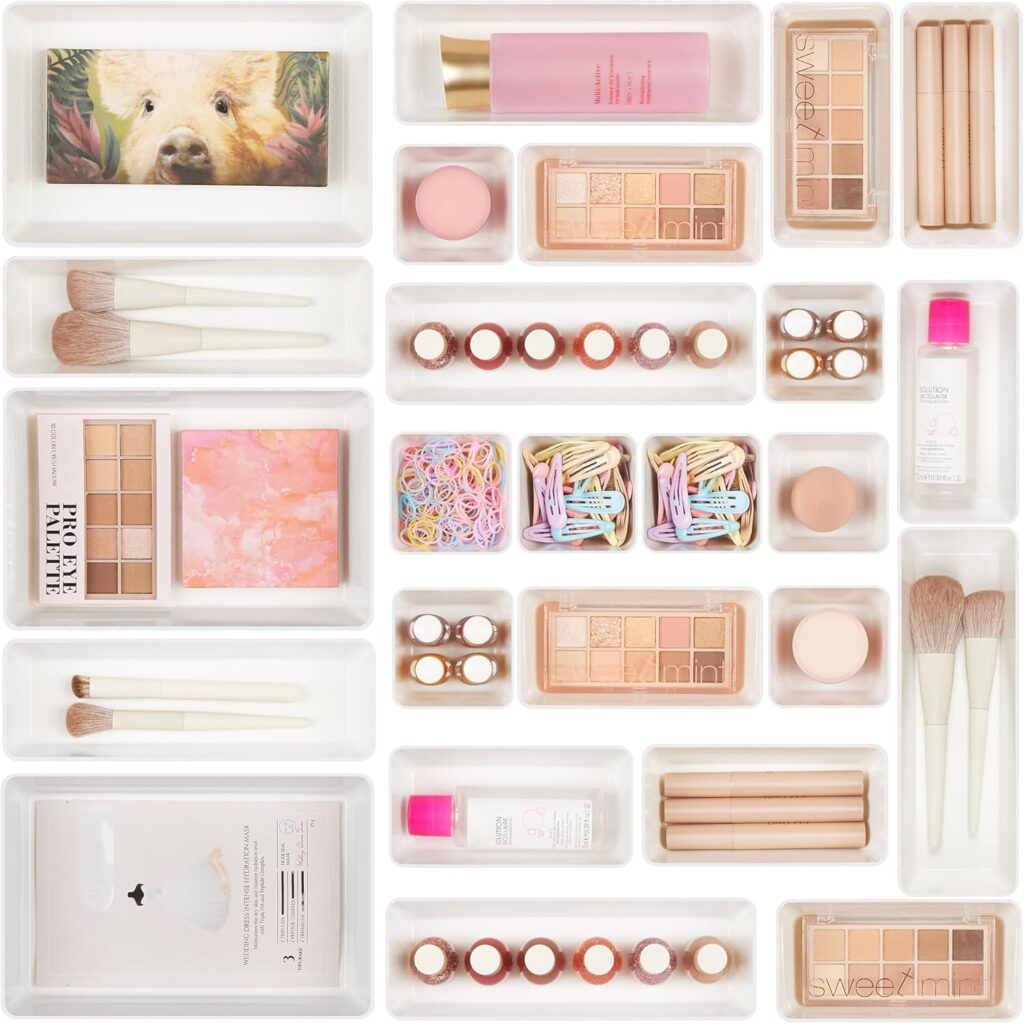 Bathroom drawer organizer trays neatly separating makeup, brushes, hair clips, and beauty products inside a vanity drawer.
