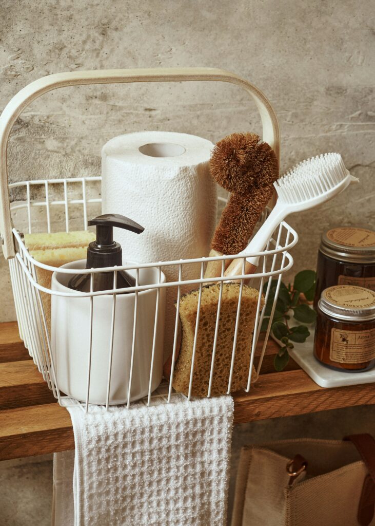 organized cleaning basket with simple home cleaning supplies and realistic reset routine aesthetic