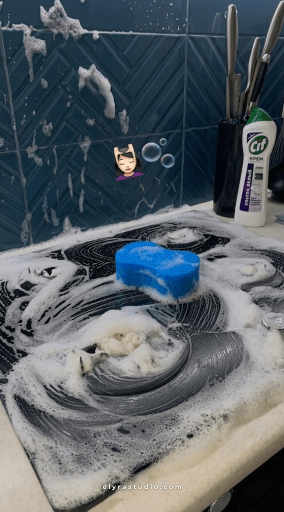 close-up of sponge cleaning kitchen surface with soap and realistic everyday cleaning routine