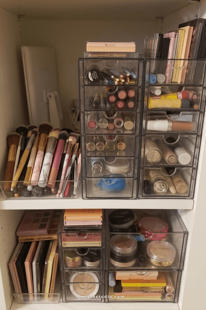 Stackable acrylic makeup storage drawers organizing palettes, powders, lip products, skincare, and beauty tools inside a vanity cabinet