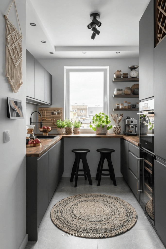 Compact kitchen with large window, extended countertop, natural light, wood finishes, and cozy small apartment design.